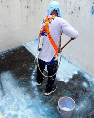 Professional waterproofing contractor repairing moisture intrusion issues