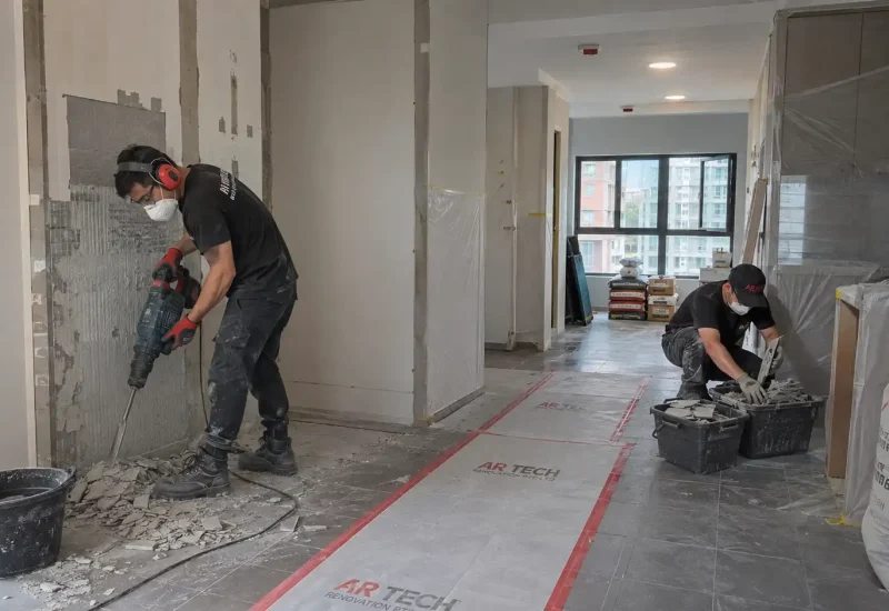 Contractors carrying out demolition and wet works in a Singapore apartment