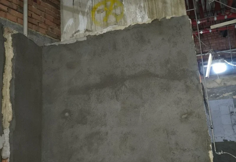 Professional plastering contractor repairing uneven wall surfaces